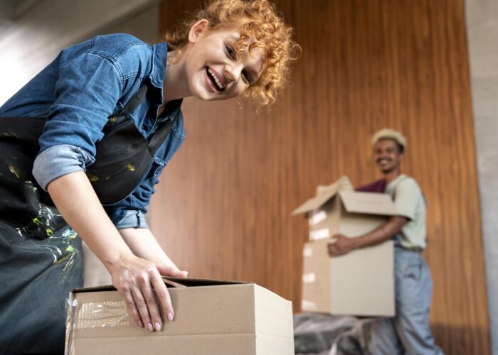 couple-with-cardboard-boxes-their-new-home